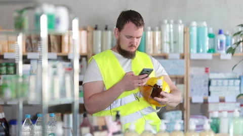 Male builder scans code on cough syrup to check the expiration date Stock Footage 321721076