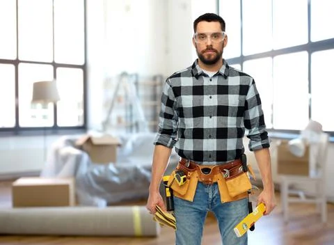 Male builder with tools and level at home Stock Photos