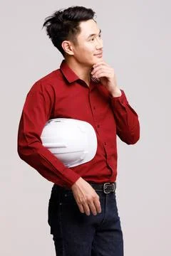 Male builder touching head in studio Stock Photos