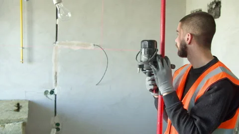 Male builder using laser level on concrete wall Stock Footage 154523310