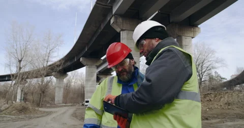 Male builders with tablet discussing data in outskirts Stock Footage 151571255