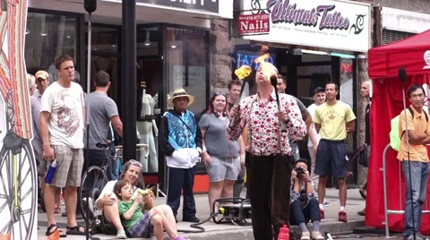 Male busker doing a fire performance on the street Stock Footage 54136278