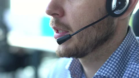 Male call center agent in headset helping client in customer support service Stock Footage