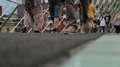 Male in canvas sneakers walking along bridge, trying its firmness by tiny jumps HD Footage