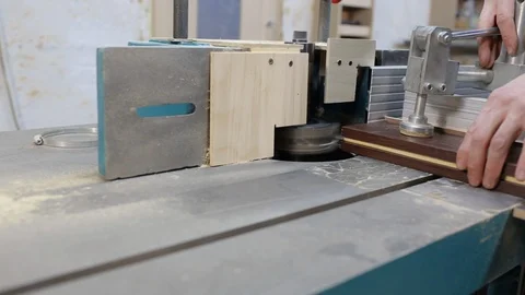 Male carpenter controls machine for cutting wood, figurine nozzle on machine Video stock 128388862