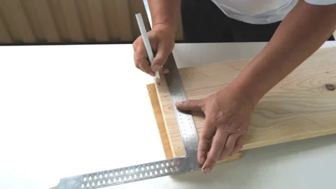 Male carpenter hands make marks on wooden board,pencil,construction square Stock Footage 162307844