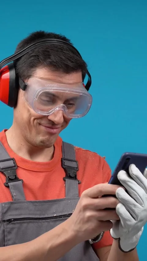 Male carpenter sending text message on smartphone Stock Footage 239908242