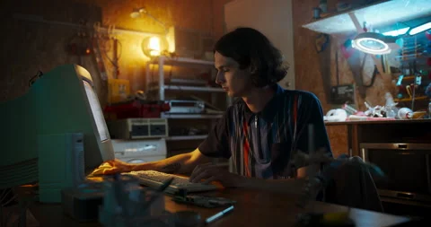 Male Caucasian Programmer Using Computer In Retro Garage Stock Footage 255999954