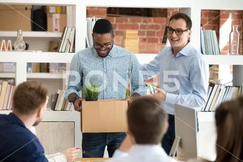 Male CEO introduce black newcomer to work team at briefing Stock Photos