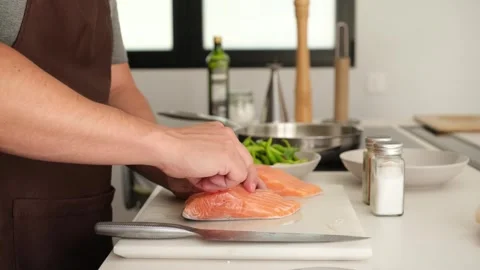 Male chef carefully removing bones from salmon fillets Stock Footage 346524736