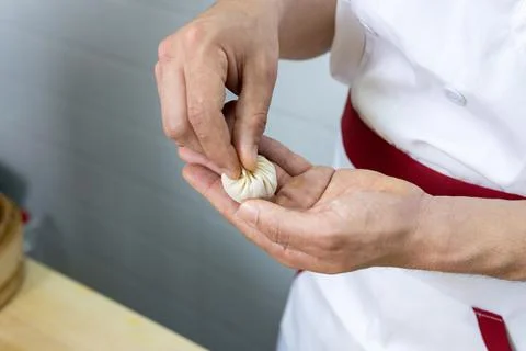 Male chef cook prepares dumplings. Stock Photos