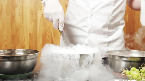 Male chef hands preparing delicious ice cream from berries using liquid nitrogen Stock Footage 137451085