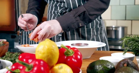 Male chef hands preparing delicious tartare from vegetables and salmon fillets Stock Footage 148476500