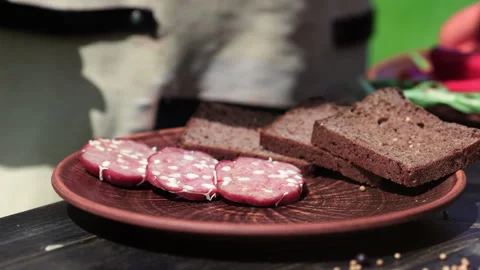 Male chef hands serving plate fresh homemade sausage and rye bread rustic Video stock 249246791