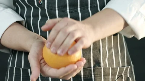 Male chef holding a orange Stock Footage 79505553