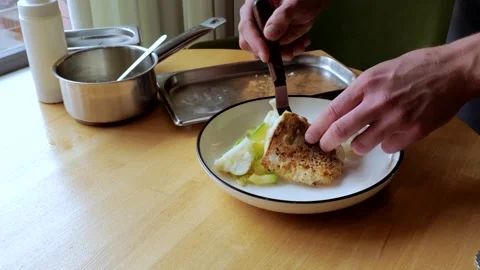 The male chef makes the composition of the dish for serving. The cook prepares a 스톡 동영상 250466730