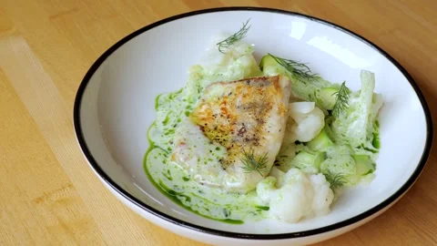 The male chef makes the composition of the dish for serving. The cook prepares a 스톡 동영상 258964500