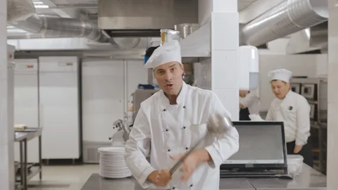 Male chef smiling happy while holding kitchen ladle and dancing Stock Footage 125049540
