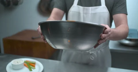 Male chef tossing chicken wings in Sriracha sauce closeup in ultra slow motion w Stock Footage 199458853