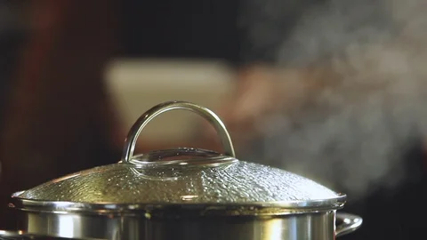 Male chef who adding salt to the casserole Stock Footage 91014192