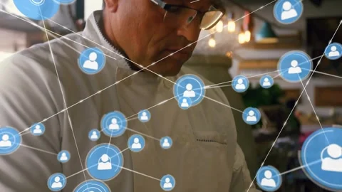 Male chef writing on notepad in kitchen while animated blue user icons expanding Stock Footage 323272556