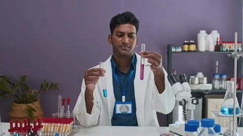 Male Chemist Telling about Difference between Reagents Stockbeeldmateriaal 305513461