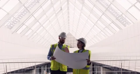Male civil engineer and female architect standing inside new business office Stock Footage