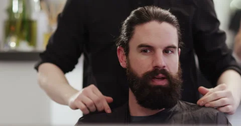 A male client having his moustache and beard groomed at a salon. Stock Footage 59740865