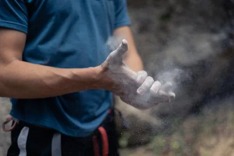Male climber's hands clapping to remove magnesium Stock Photos