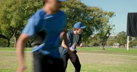 Male coach and trainee throwing disc on field at park, whistle, orange disc, Stock Footage 335130030