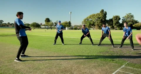 Male coach using bat, flicking ball, triggers team retrieving, tossing, and Video stock 337159450