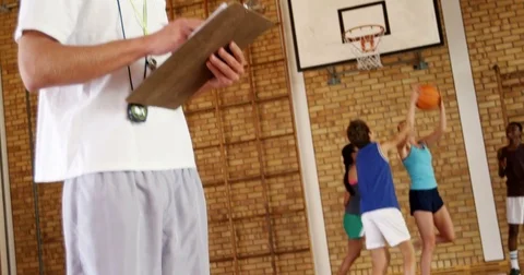 Male coach writing on clipboard Stock Footage