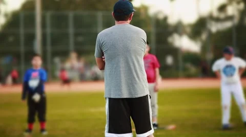 Male coaching kids during practice at Baseball Field Stock Footage 47713271