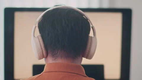 Male Coder in Headphones Working on Computer Stock Footage 265071145