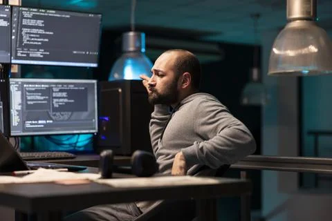 Male coder sitting and dancing with satisfaction in office 스톡 사진