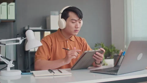 Male Coder Testing App on Digital Tablet and Laptop Stock Footage 265068294