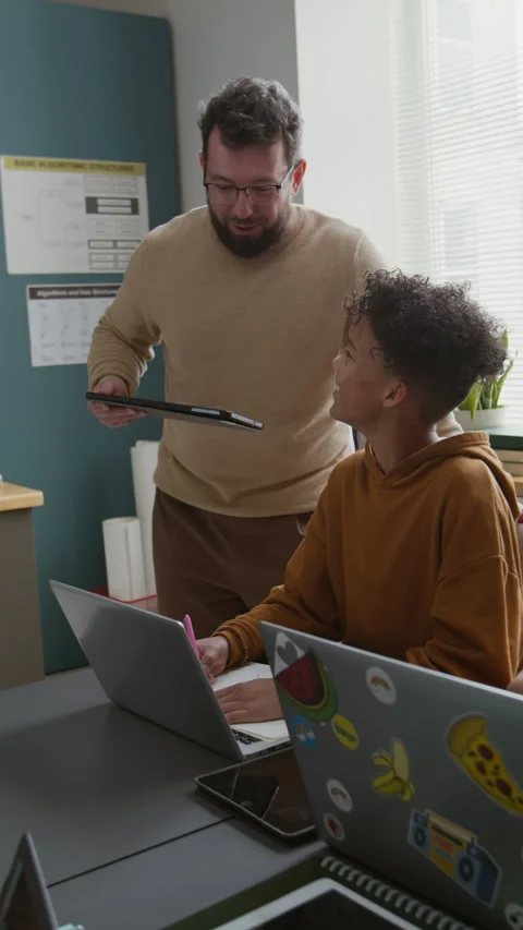 Male Coding Teacher Checking on Boy Drawing Script Algorithm in Notebook Stock Footage 318718993