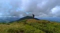 The male with a color smoke bomb standing on the picturesque mountain 4k or 4k+ Resolution