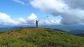 The male with a color smoke bomb standing on the picturesque mountain 4k or 4k+ Resolution