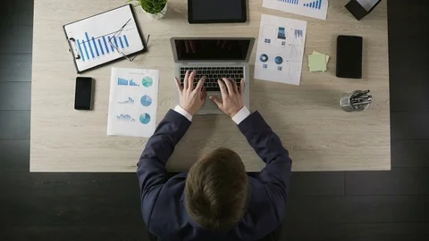 Male company director typing on laptop, planning project or business strategy Stock Footage