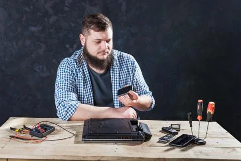 Male computer engineer fixing problem with laptop Stock Photos