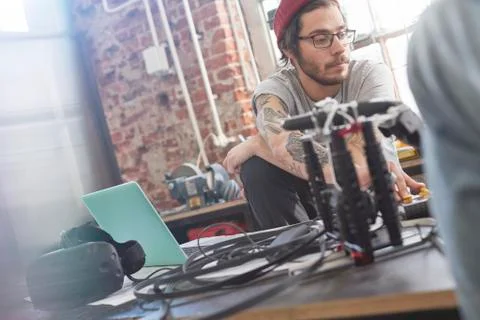 Male computer programmer programming electronics in workshop 스톡 사진