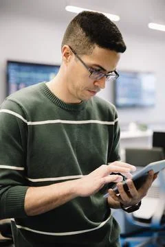 Male computer programmer using digital tablet in office 写真素材
