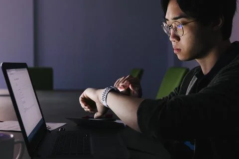 Male computer programmer working late at laptop in office 스톡 사진