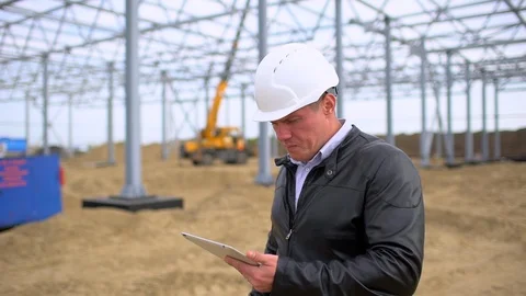 Male construction engineer architect supervisor in hard hats working checking Stock Footage 98365484