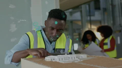 Male construction pro checking scale model, tapping tablet and starting AR Stock Footage 337236483