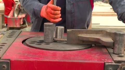 Male Construction worker bends iron bars on a workbench Stock Footage 255007956