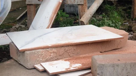 Male construction worker cutting ceramic tiles using grinder Stock Footage 307557564