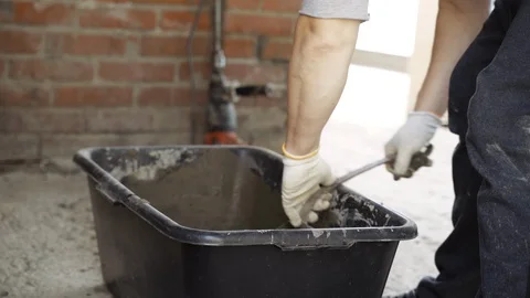 Male Construction Worker Guest Worker Pulls Out Cement Video stock 129344000