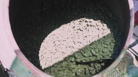 Male construction worker making concrete mix using cement mixer spinning slow Stock Footage 278364938